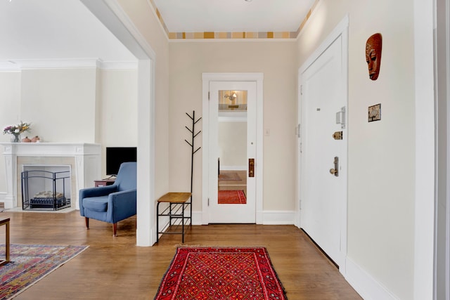 entrance foyer featuring wood-type flooring and crown molding