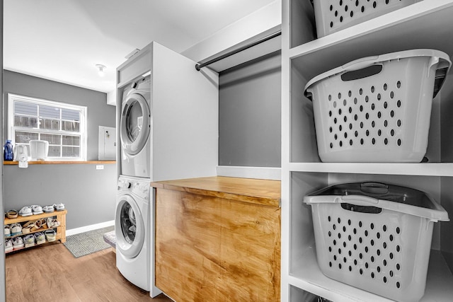 4661 W Tulip Ave, Monee, IL 60449 - laundry area with stacked washer / dryer, wood finished floors, and baseboards