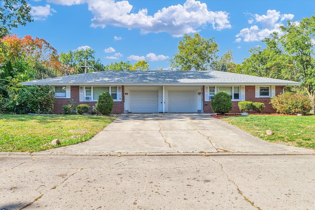 ranch-style home with a front yard and a garage