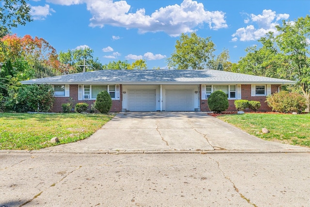 ranch-style home with a front yard and a garage