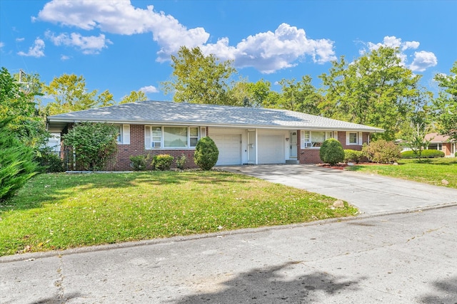 single story home featuring a garage and a front lawn