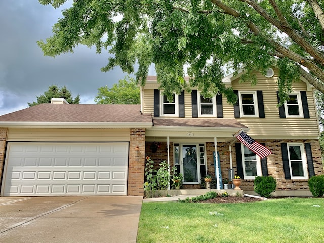 view of front of property featuring a garage, a front yard, and covered porch