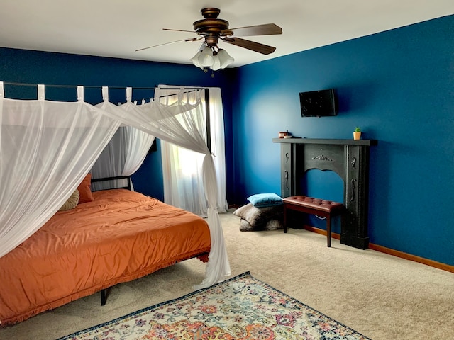 bedroom featuring ceiling fan and carpet