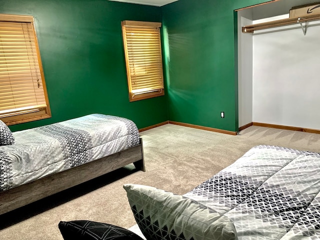 carpeted bedroom with a closet