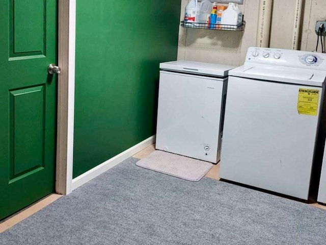 clothes washing area featuring separate washer and dryer and light colored carpet