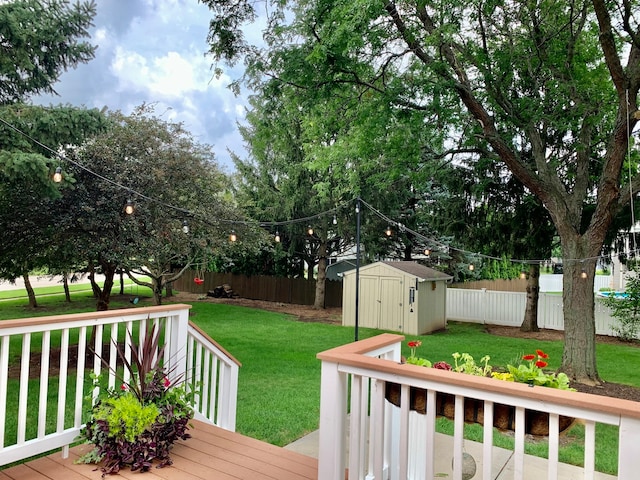 wooden deck with a yard and a storage unit