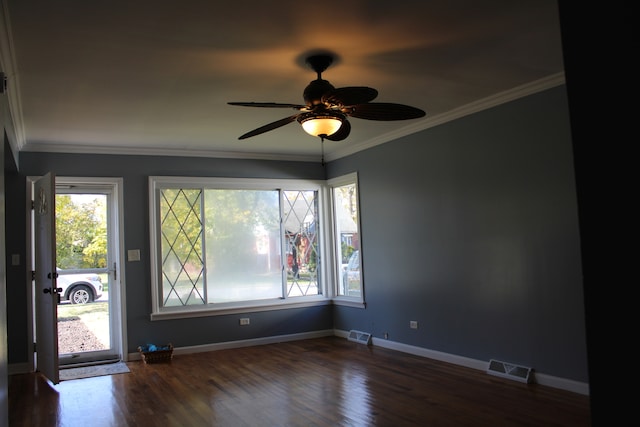 unfurnished room with crown molding, ceiling fan, and dark hardwood / wood-style floors