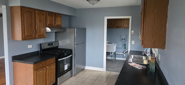 kitchen with stainless steel range, light hardwood / wood-style floors, and sink