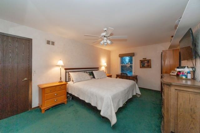 bedroom featuring ceiling fan and dark carpet