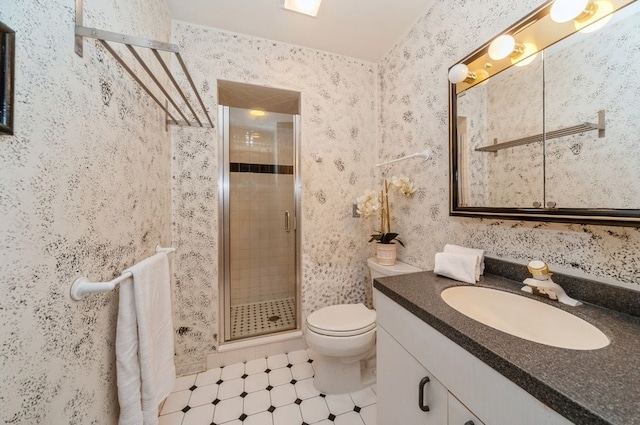 bathroom featuring vanity, toilet, and a shower with door