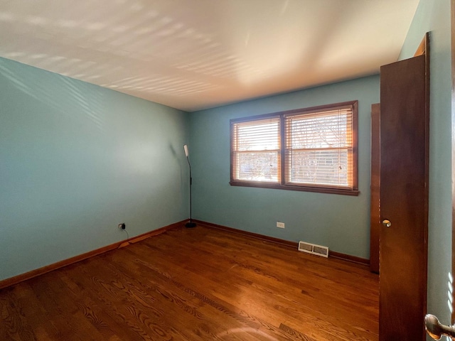 spare room with hardwood / wood-style floors