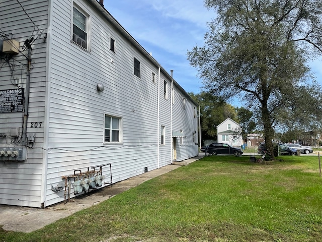 view of side of property with a yard