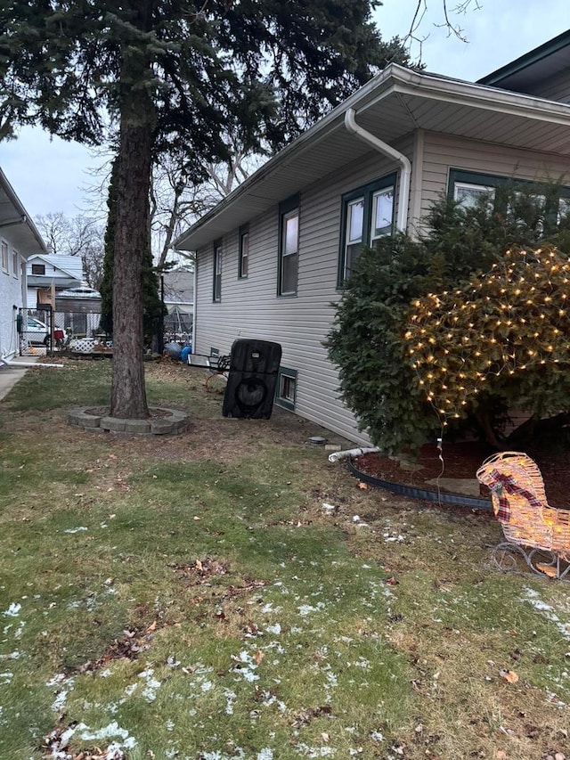 view of side of home with a lawn