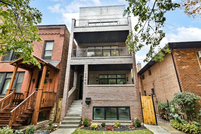 back of property featuring a balcony