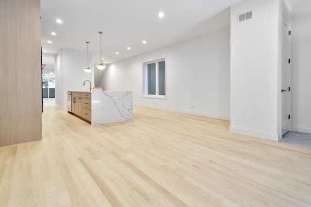 interior space featuring sink and light wood-type flooring