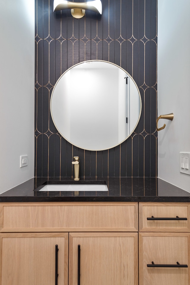 bathroom with vanity and backsplash