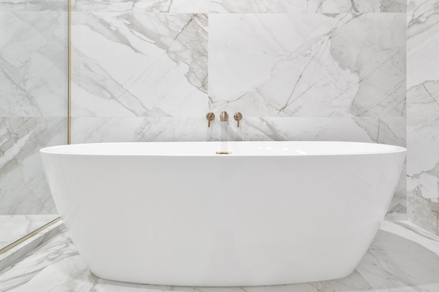 bathroom featuring a bathing tub and tile walls