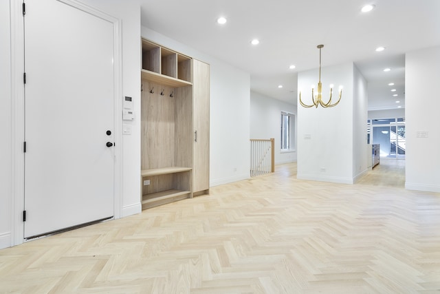 mudroom featuring a notable chandelier and light parquet flooring