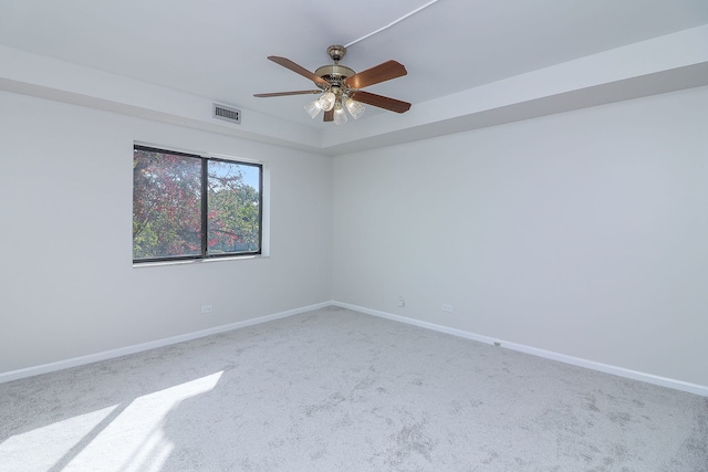 spare room with ceiling fan and carpet