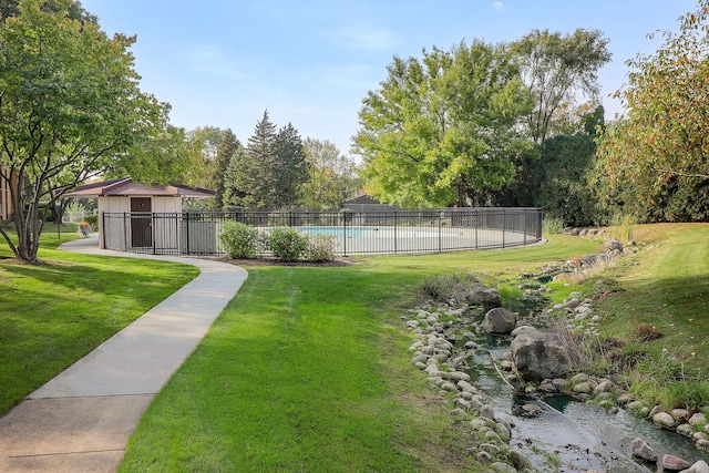 view of yard with a fenced in pool