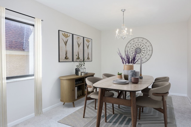 carpeted dining room with a chandelier