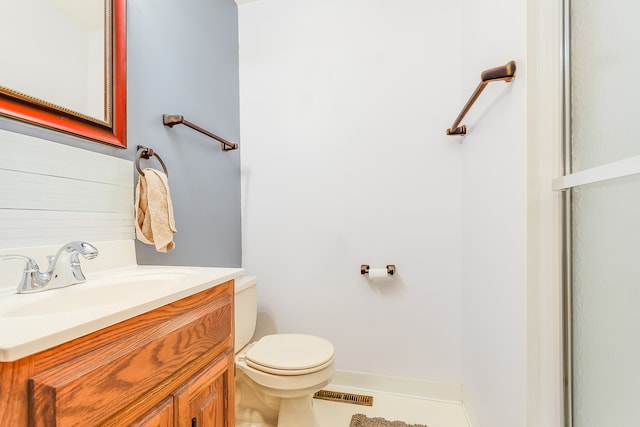 bathroom with vanity, tile patterned flooring, and toilet