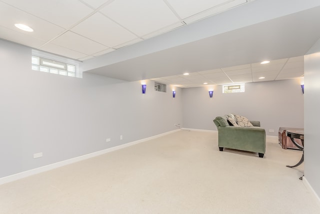 basement with light colored carpet and a drop ceiling