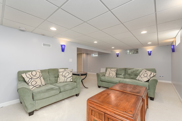 carpeted living room featuring a paneled ceiling