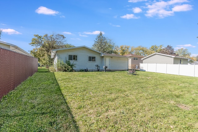 back of property featuring a lawn