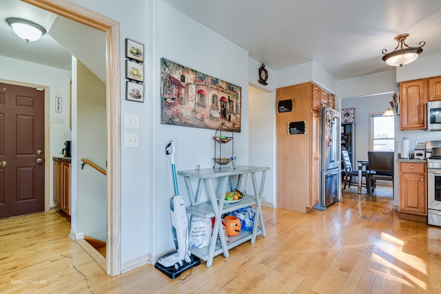 kitchen featuring appliances with stainless steel finishes and light wood-type flooring