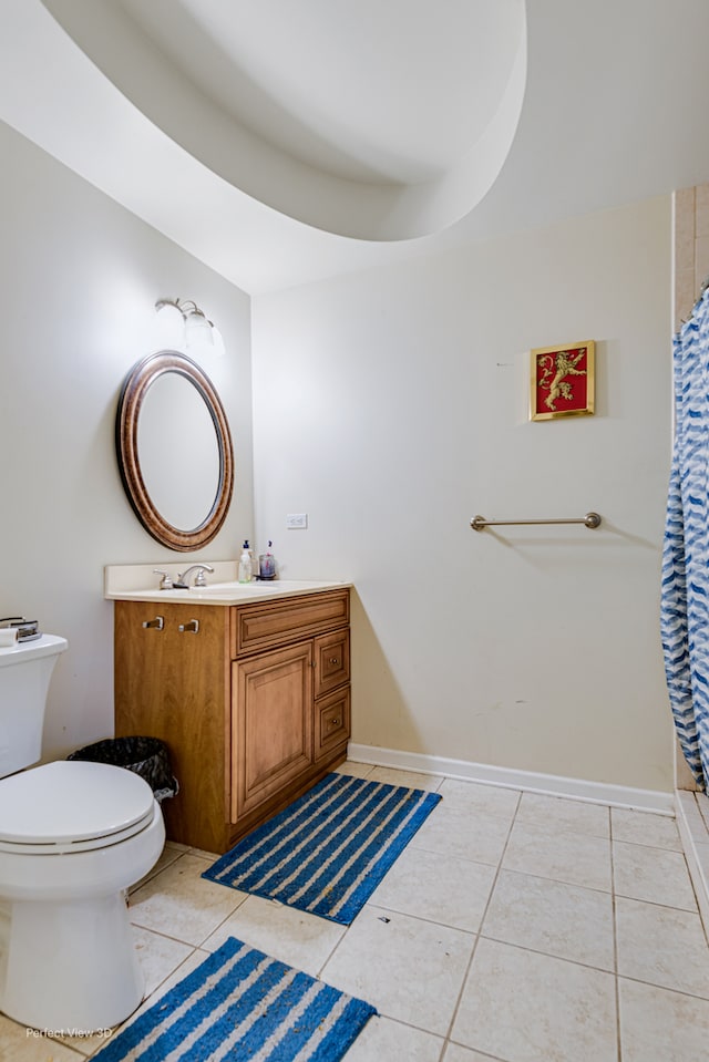 bathroom featuring walk in shower, vanity, tile patterned flooring, and toilet