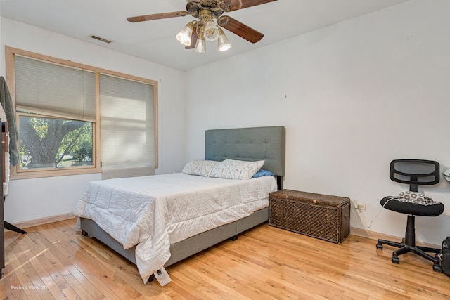 bedroom with wood-type flooring and ceiling fan