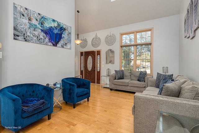 living room featuring a high ceiling and hardwood / wood-style flooring