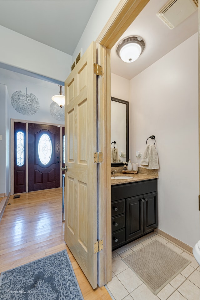 bathroom with wood-type flooring and vanity