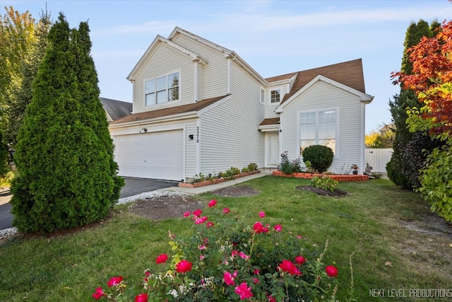 view of front property featuring a front lawn and a garage