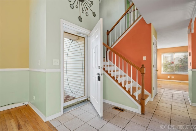 foyer with light hardwood / wood-style floors and a notable chandelier