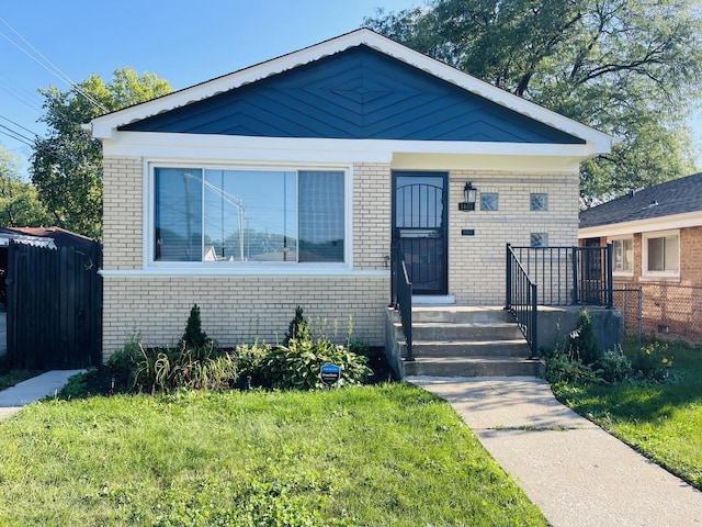 bungalow-style home featuring a front lawn