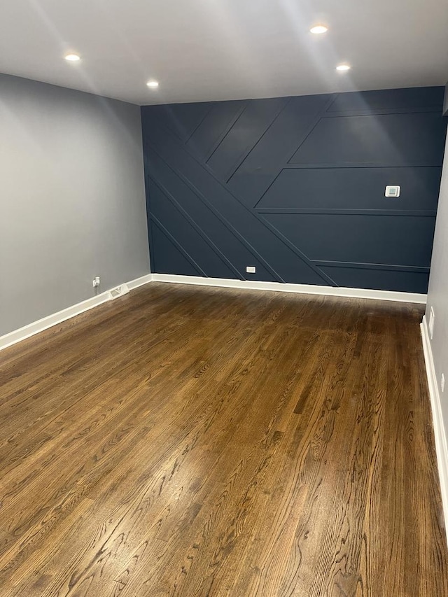 1409 E 90th St, Chicago, IL 60619 - empty room featuring recessed lighting, a decorative wall, baseboards, and dark wood-style flooring