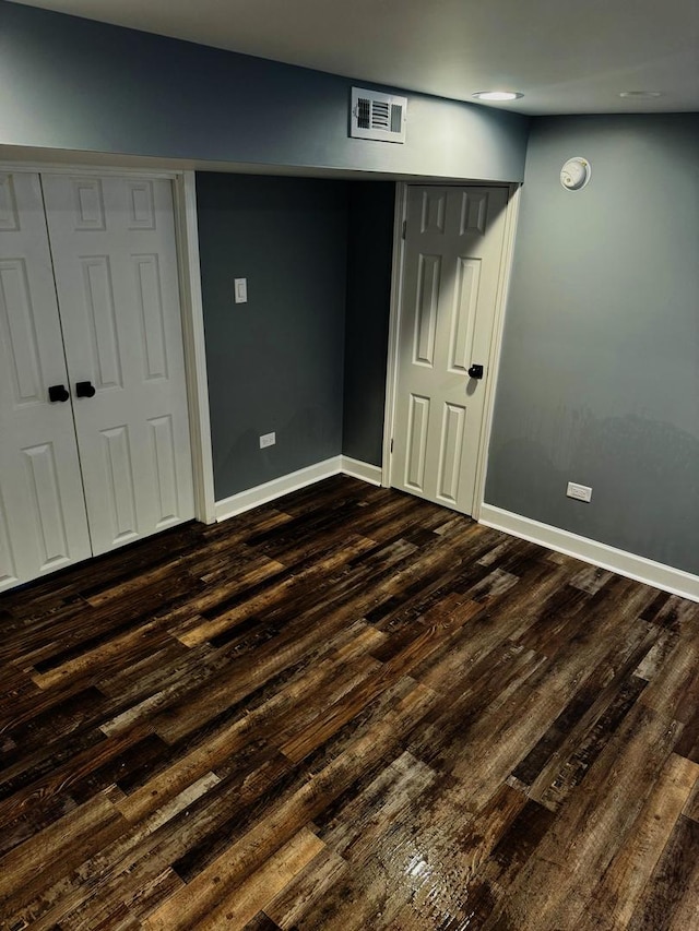 bedroom featuring a closet and dark hardwood / wood-style floors