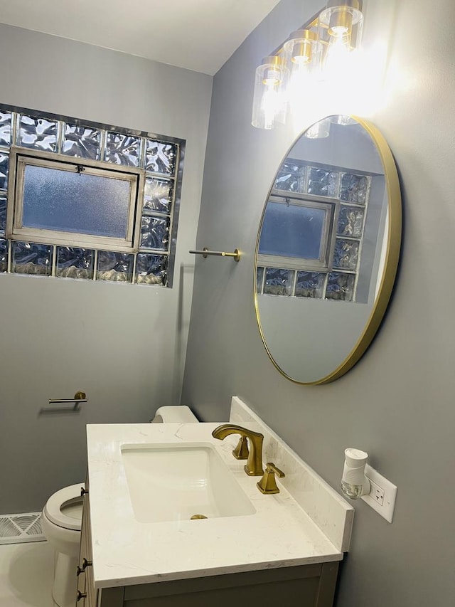 1409 E 90th St, Chicago, IL 60619 - bathroom featuring visible vents, toilet, and vanity