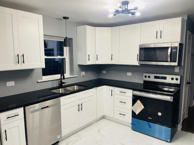 1409 E 90th St, Chicago, IL 60619 - kitchen featuring a sink, marble finish floor, appliances with stainless steel finishes, white cabinetry, and a notable chandelier