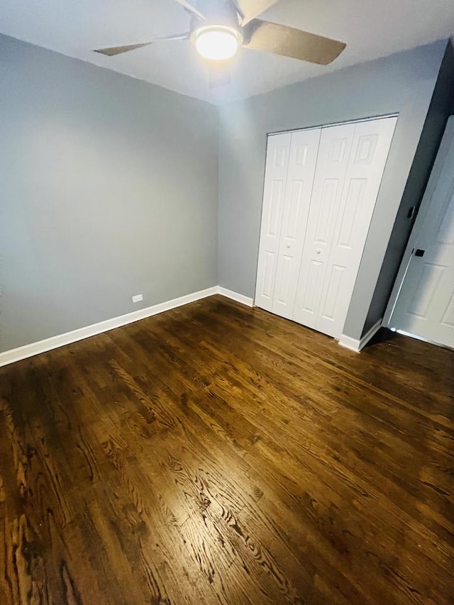 1409 E 90th St, Chicago, IL 60619 - unfurnished bedroom featuring ceiling fan, baseboards, dark wood-style floors, and a closet