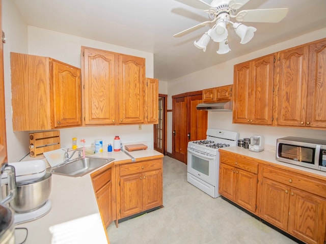 kitchen with ceiling fan, sink, and white range with gas cooktop