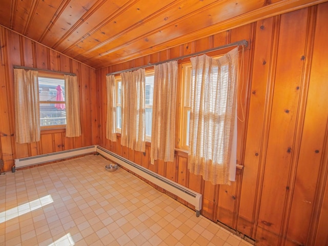 interior space featuring wood walls, wood ceiling, and baseboard heating