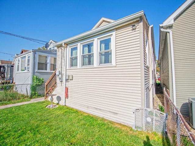 view of side of home with a lawn