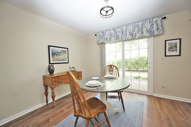 dining area featuring dark wood-type flooring