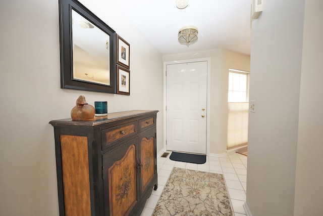 foyer entrance with light tile patterned floors