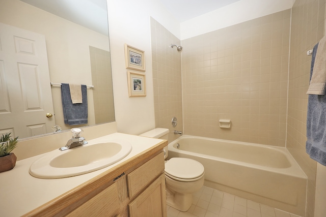 full bathroom featuring tile patterned floors, vanity, toilet, and tiled shower / bath combo