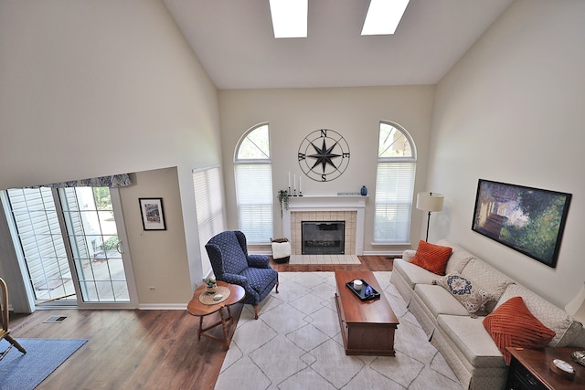 living room featuring light wood-type flooring and a tile fireplace