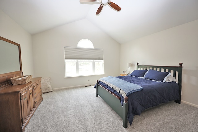 bedroom with ceiling fan, light carpet, and vaulted ceiling